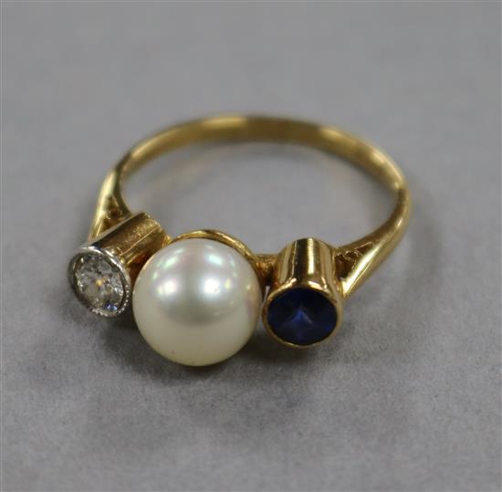 An 18ct yellow gold, cultured pearl, sapphire and diamond three-stone ring, size L.